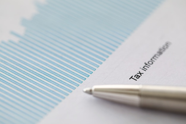 A close-up shot of a tax form highlighting sections for standard and itemized deductions with a pen resting on top.